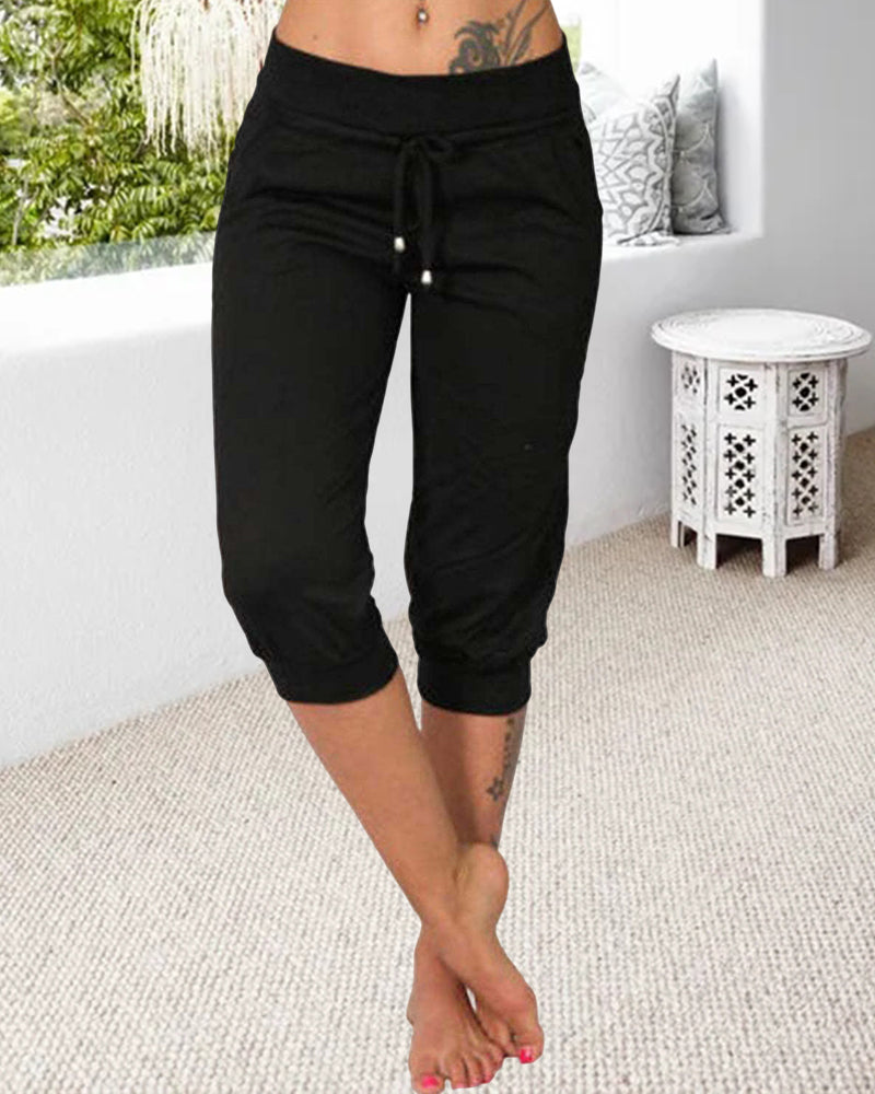 Pantalon à 3/4 longue avec poche de couleur unie